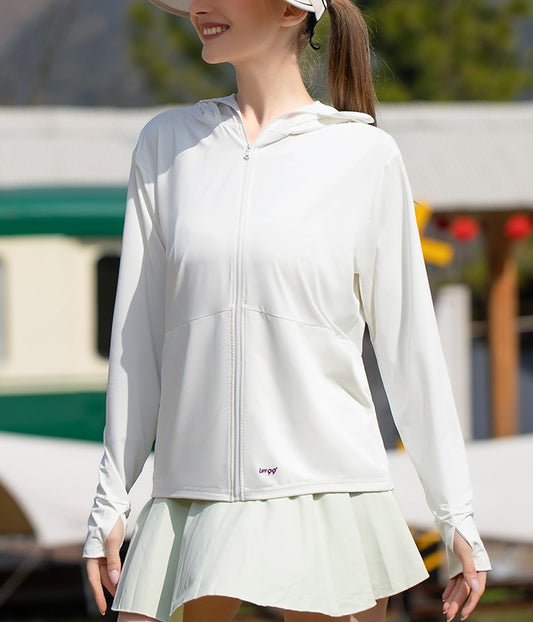 Woman wearing a white sun protection jacket with a hood and a pleated skirt.