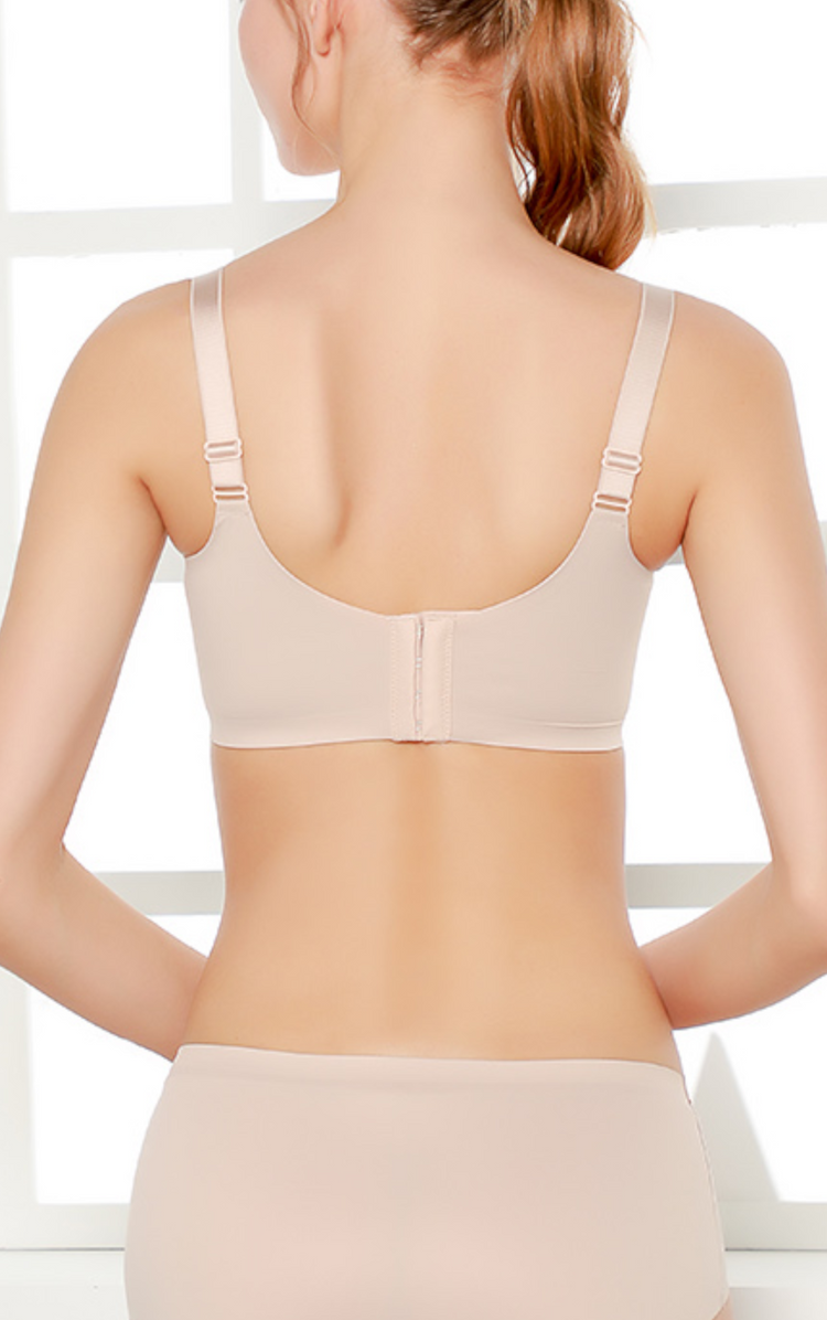 Back view of a beige  lace bra with wide adjustable straps and smooth sidebands for back-smoothing support.