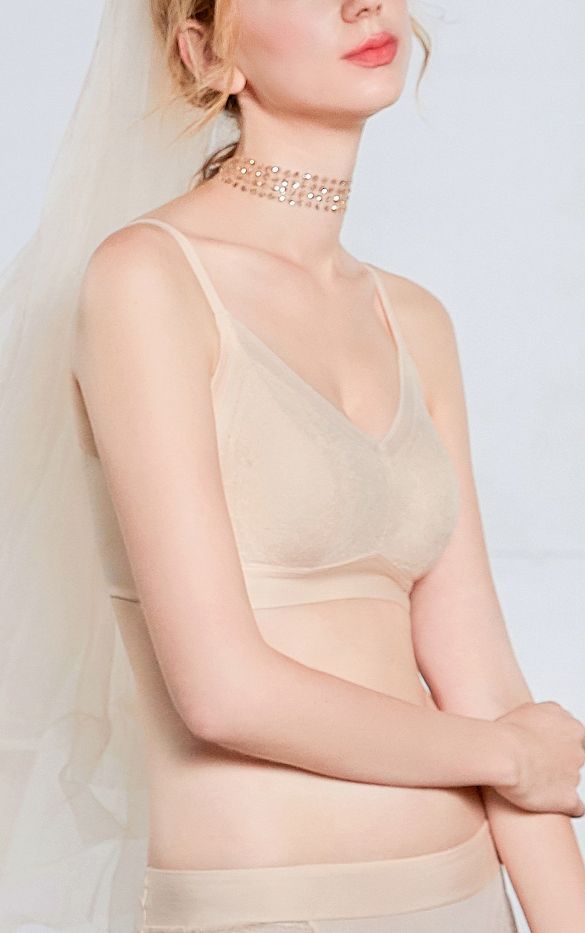 Angled view of beige wireless contour bra highlighting wide sidebands for back-smoothing support