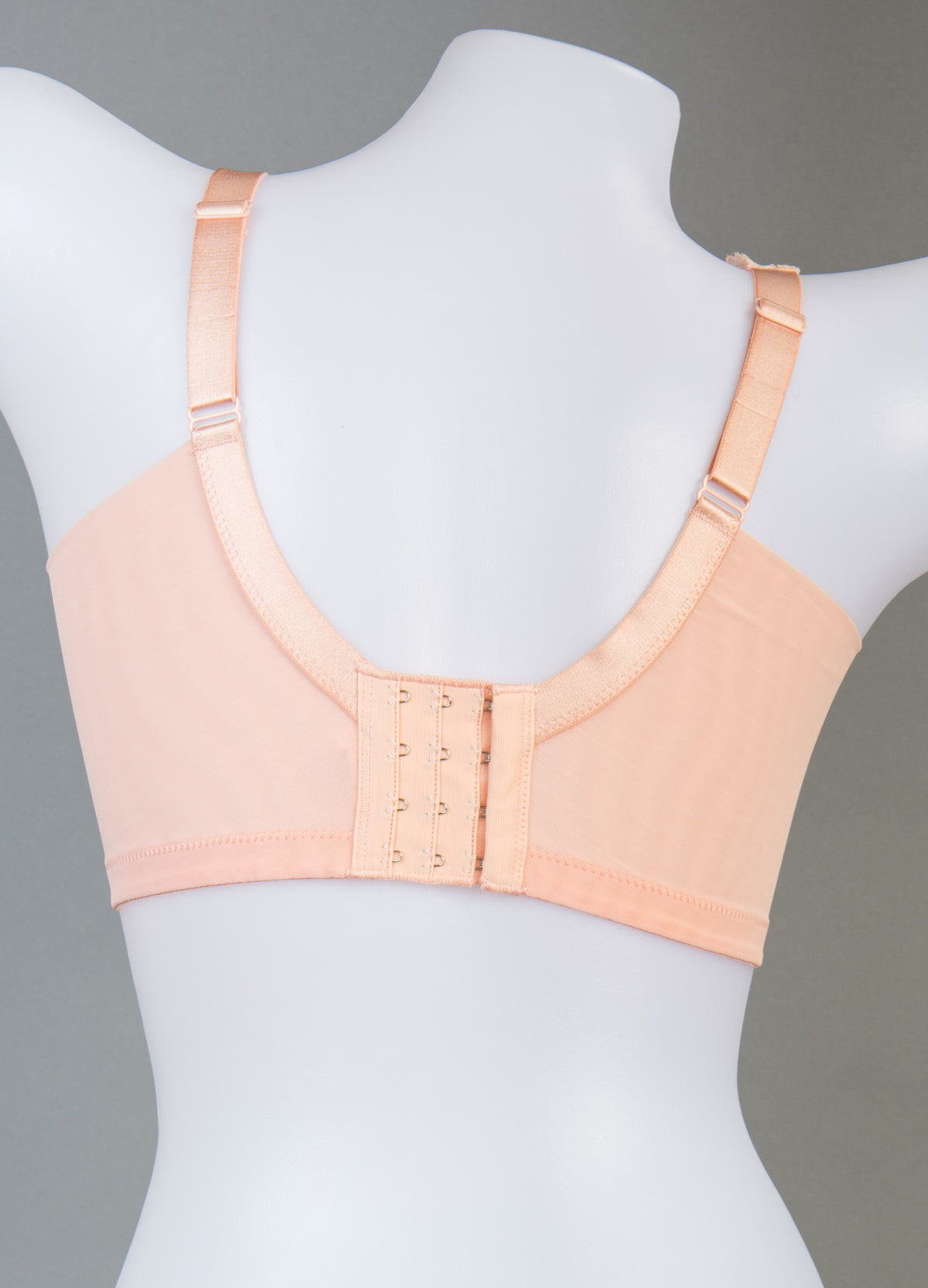 Back view of orange wireless full coverage contour bra highlighting adjustable straps