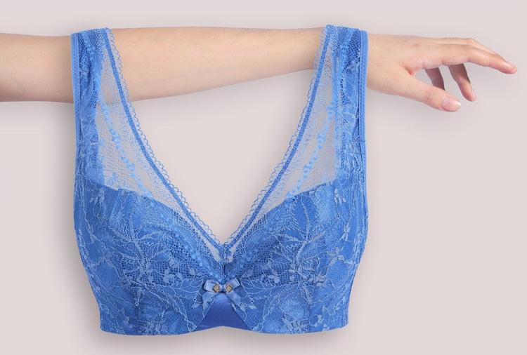 Close-up of a blue lace minimizer bra laid flat, displaying intricate lace patterns and soft underwire construction for contouring and comfort.